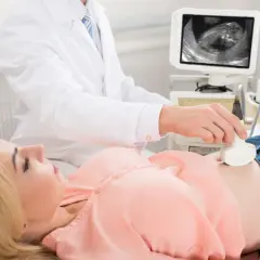 Lekarz wykonuje USG, badanie prenatalne, które jest kluczowe dla zdrowia i długowieczności dziecka.